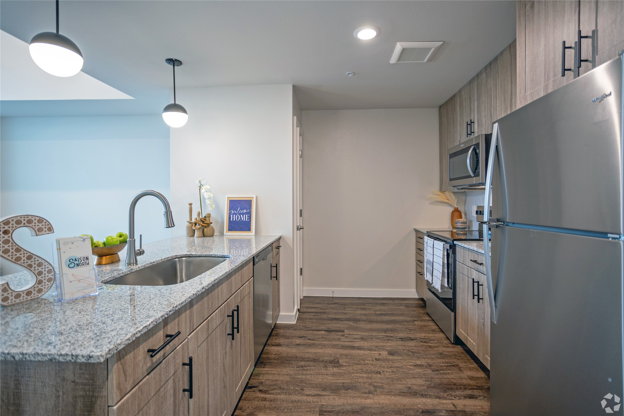 10010 North Capital Of Texas Highway, Unit 116 Austin, TX 78759 - Photo 15 of 20 a kitchen with granite countertop a sink and a refrigerator