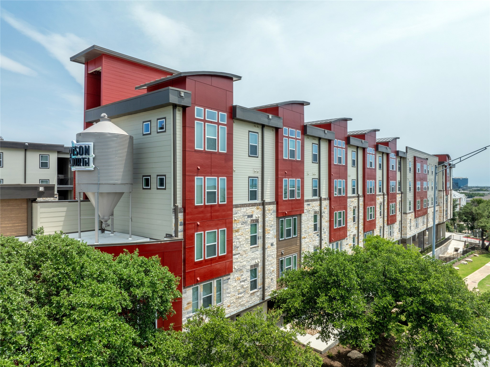 10010 North Capital Of Texas Highway, Unit 116 Austin, TX 78759 - Photo 19 of 20 a front view of multi story residential apartment building with yard and bench