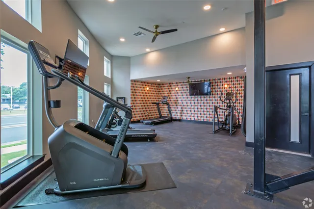 a room with gym equipment and windows