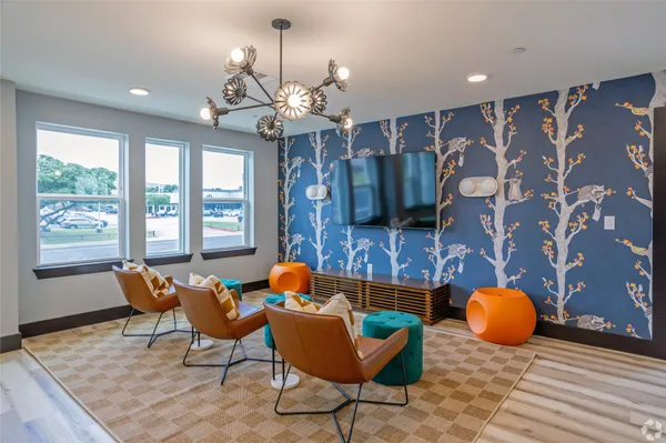 a living room with furniture a flat screen tv and a large window