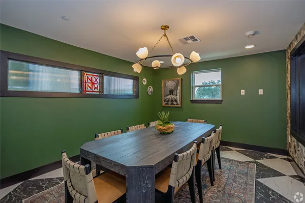 a view of a dining room with furniture and chandelier