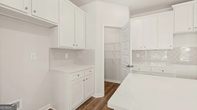 a view of a kitchen with a sink and dishwasher a refrigerator with wooden floor