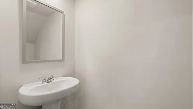 a spacious bathroom with 2 sink and a mirror