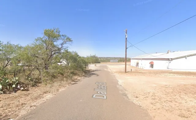 a view of a road with a building in the background