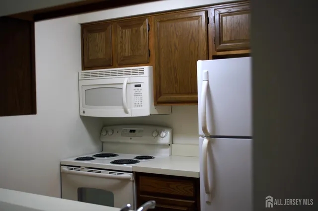 a kitchen with a refrigerator and a stove