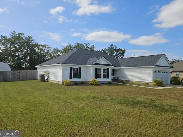 a front view of a house with a garden