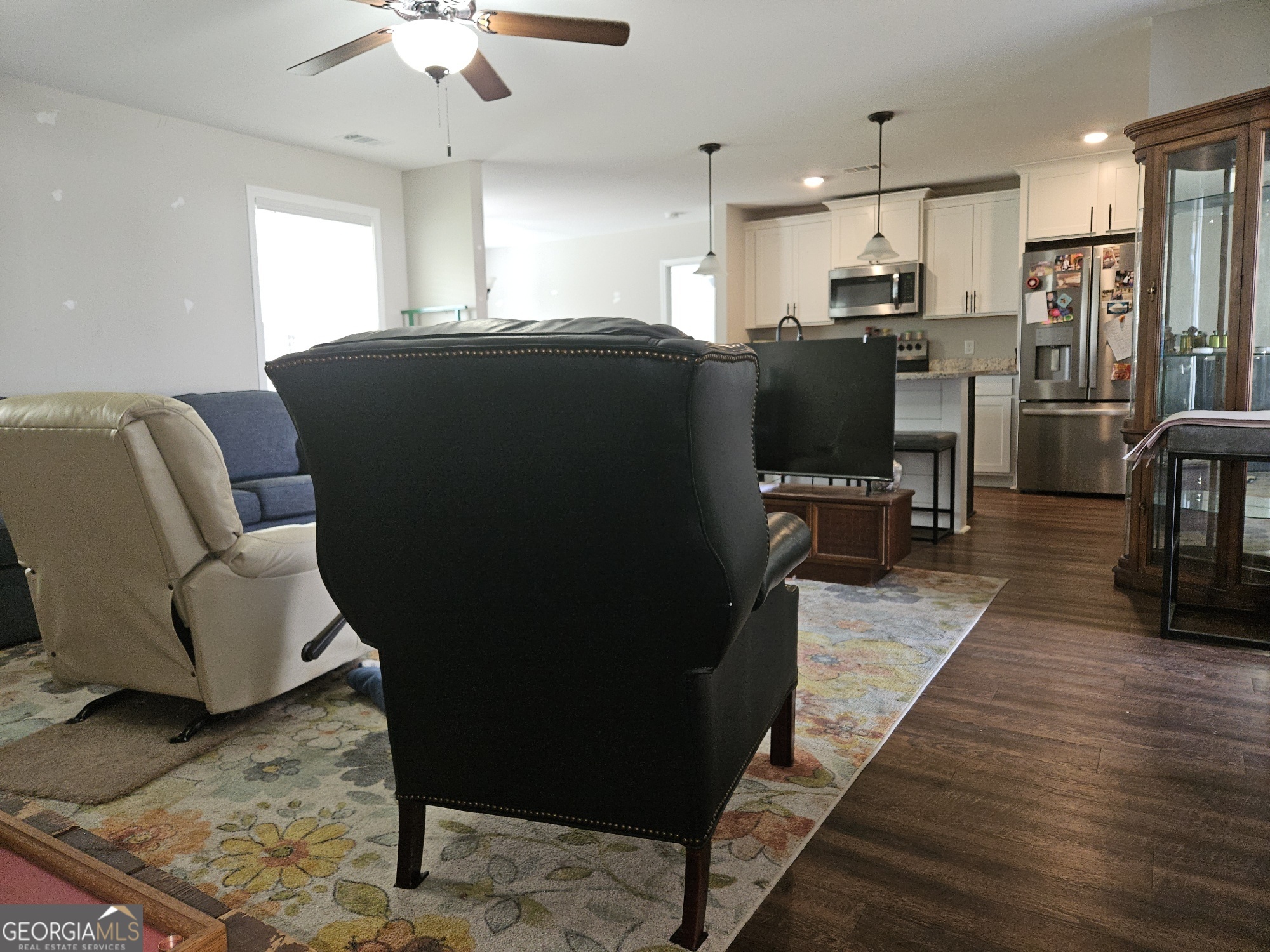 101 Old Barn Road Statesboro, GA 30458 - Photo 14 of 16 a living room with stainless steel appliances kitchen island granite countertop furniture a rug a fireplace and a kitchen view
