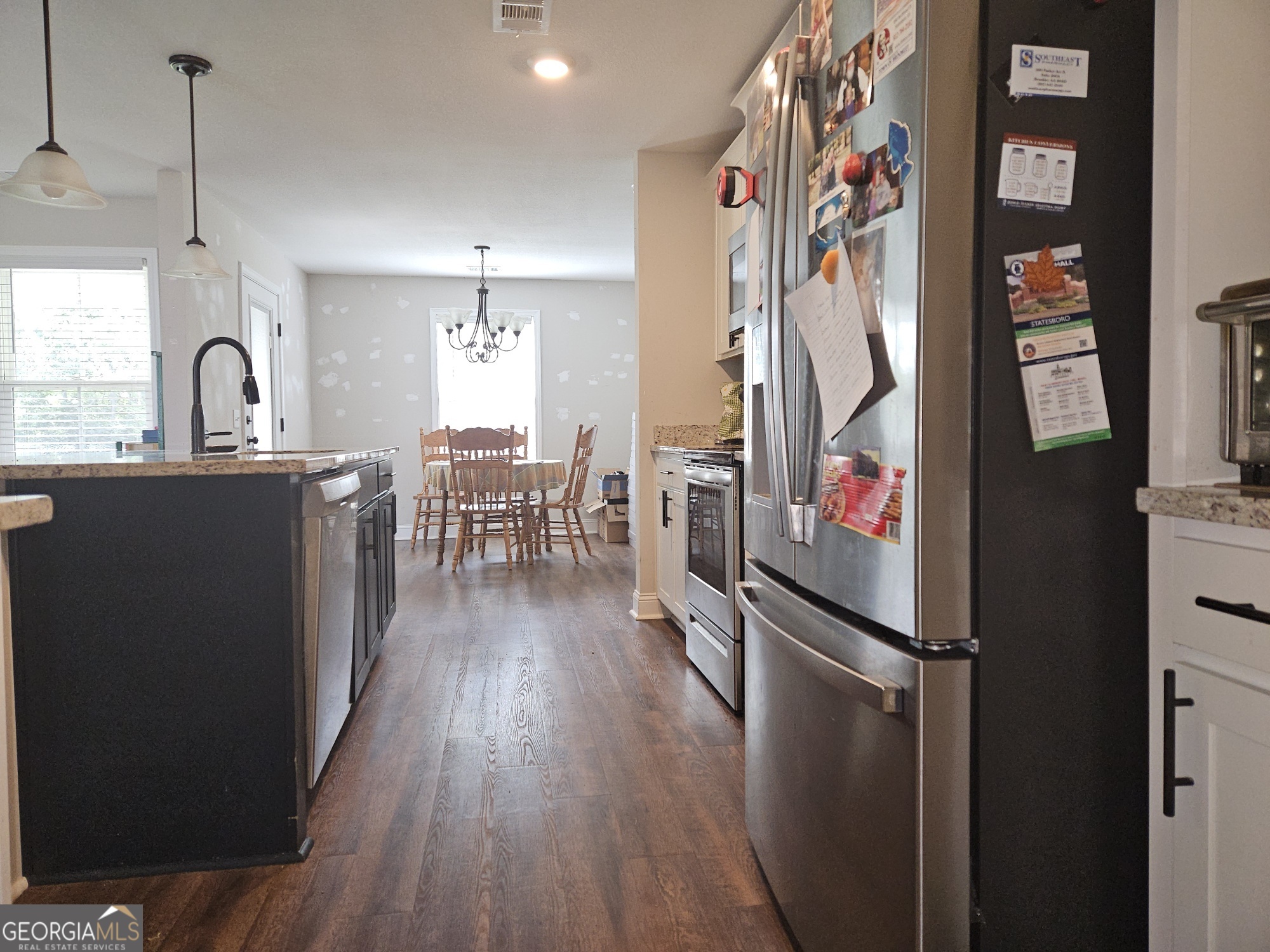 101 Old Barn Road Statesboro, GA 30458 - Photo 15 of 16 a kitchen with stainless steel appliances granite countertop a refrigerator a stove top oven a sink and dishwasher a oven with wooden floor