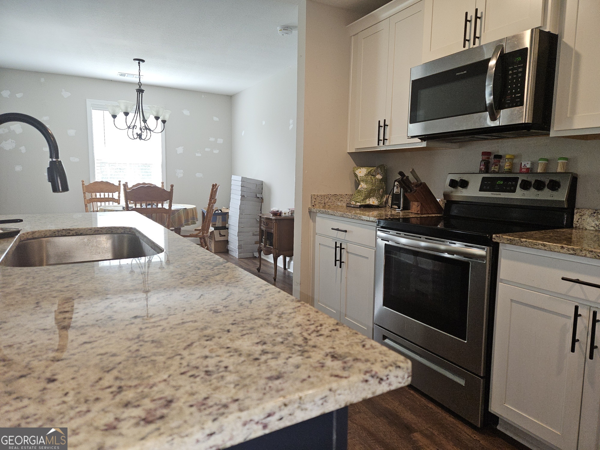 101 Old Barn Road Statesboro, GA 30458 - Photo 16 of 16 a kitchen with stainless steel appliances kitchen island granite countertop a sink stove and microwave