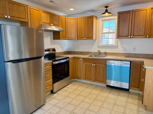 a kitchen with a sink appliances and cabinets