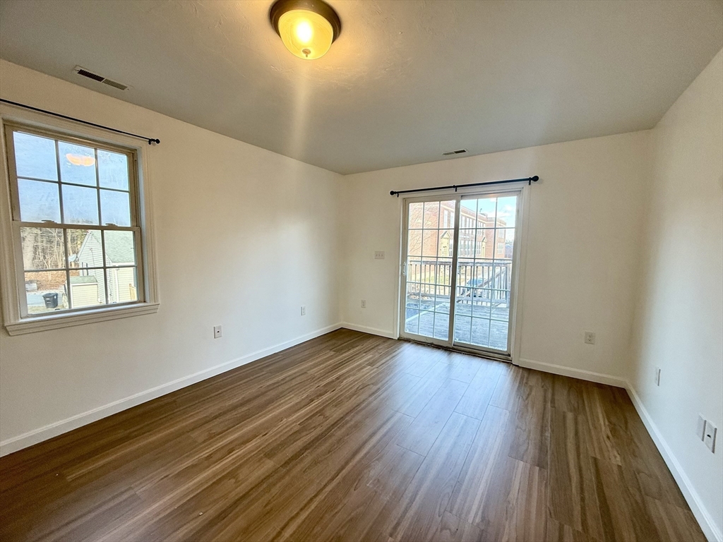 136 Eastford Road, Unit 2 Southbridge, MA 01550 - Photo 6 of 13 a view of an empty room with wooden floor and a window