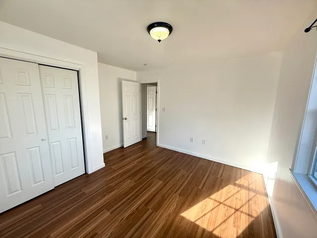 a view of a room with wooden floor