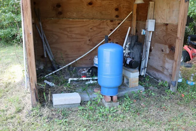a view of a hallway with a dining table and chairs