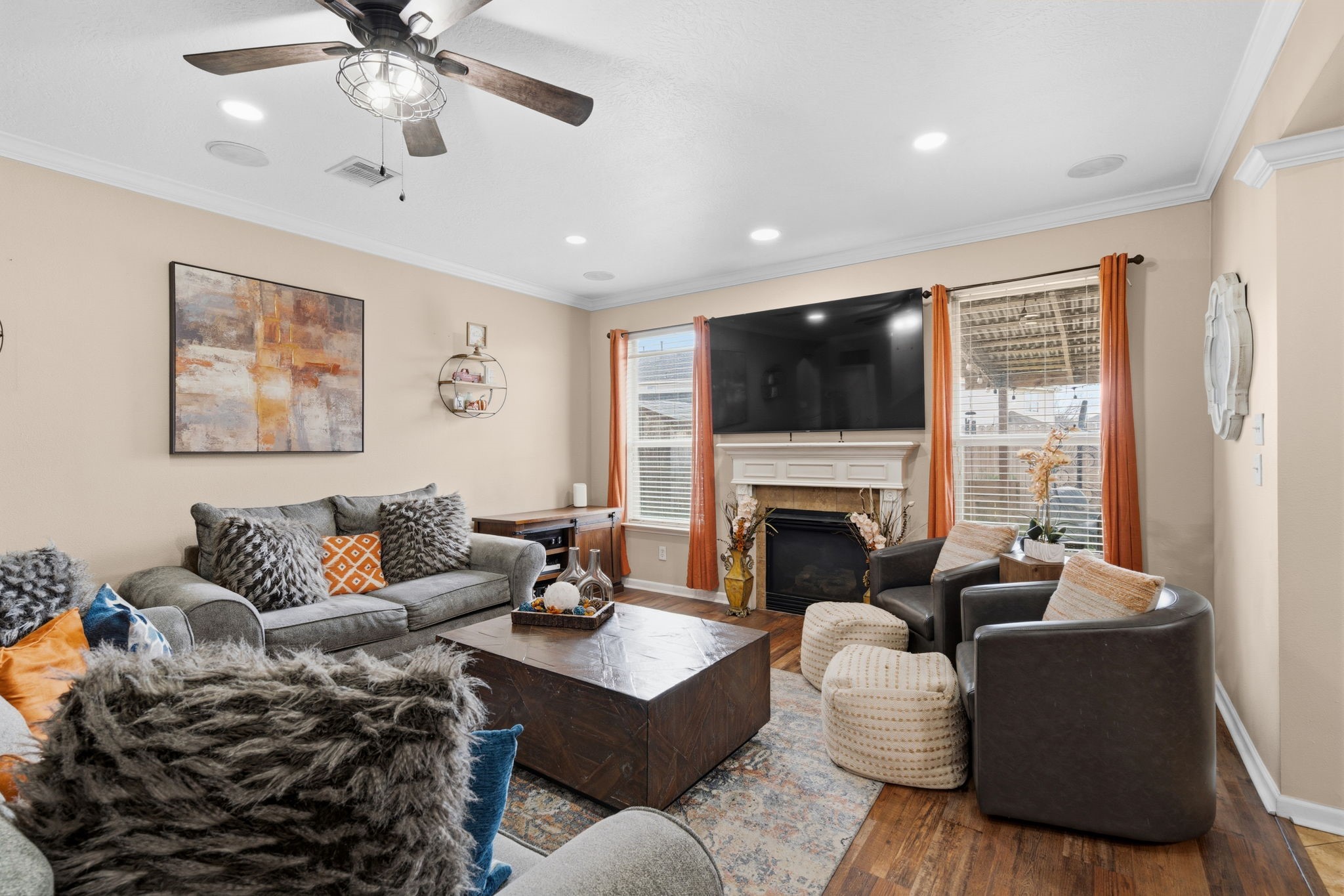 1319 Collier Point Lane Fresno, TX 77545 - Photo 4 of 33 Spacious living room serves as the heart of the home, anchored by a cozy fireplace and an impressive entertainment wall perfect for relaxing evenings or hosting guests.