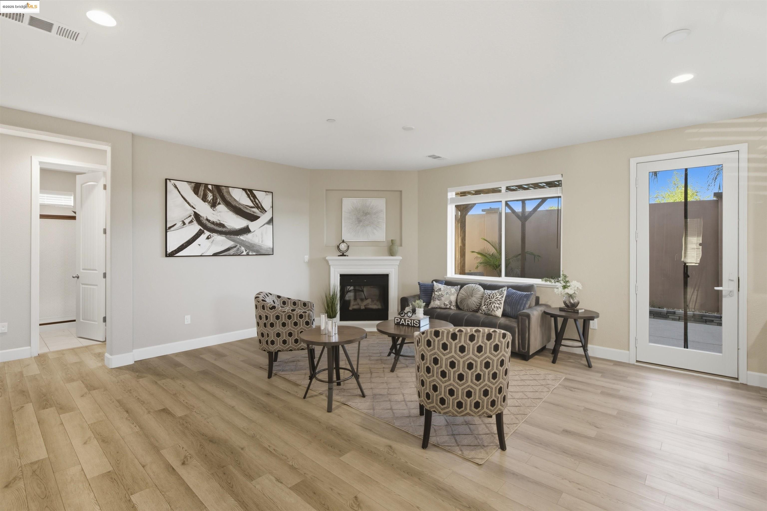 536 Aster Street Vacaville, CA 95688 - Photo 16 of 53 Living room with recessed lighting, light wood-type flooring, and a glass covered fireplace