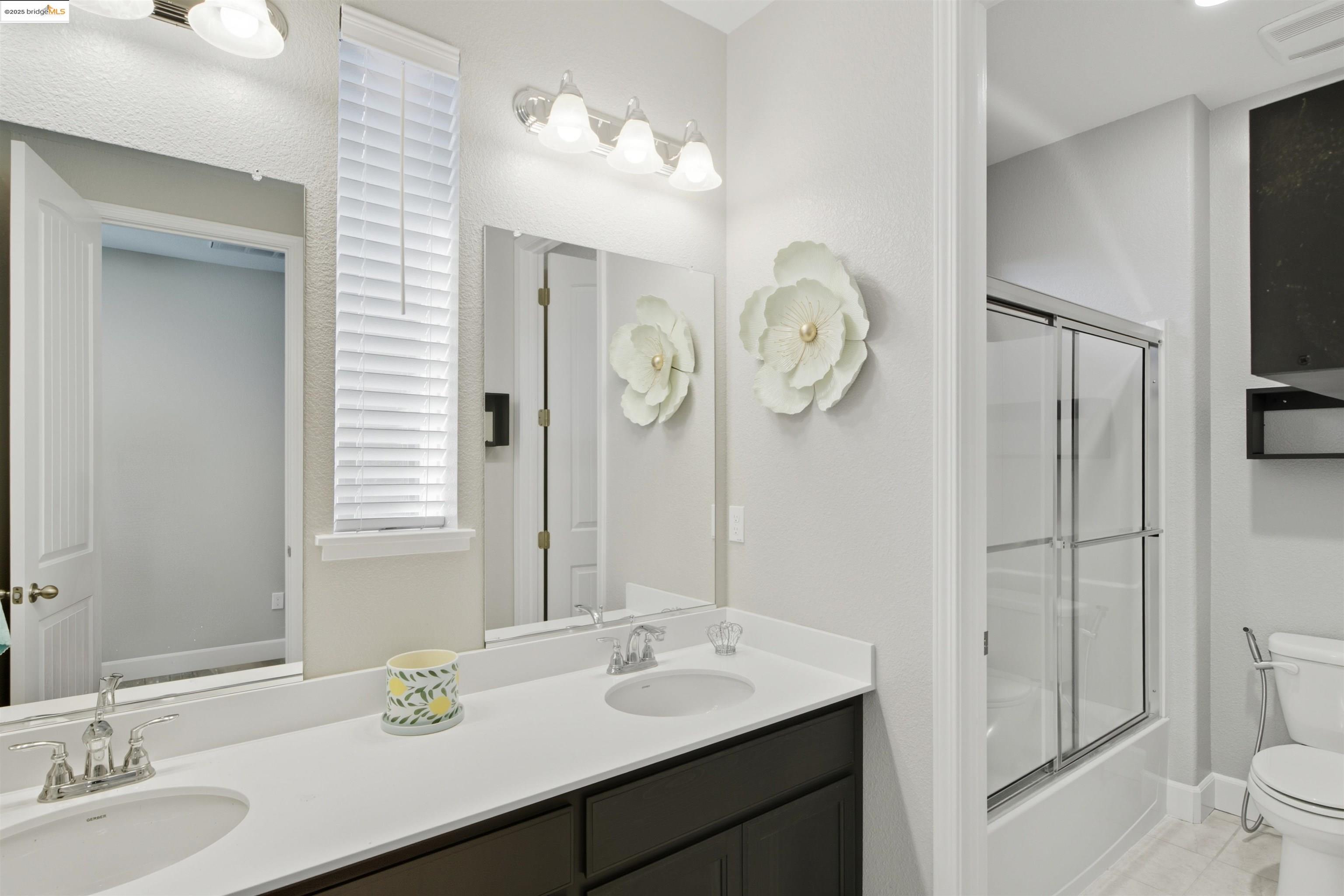 536 Aster Street Vacaville, CA 95688 - Photo 33 of 53 Full bathroom featuring bath / shower combo with glass door, double vanity, and light tile patterned floors