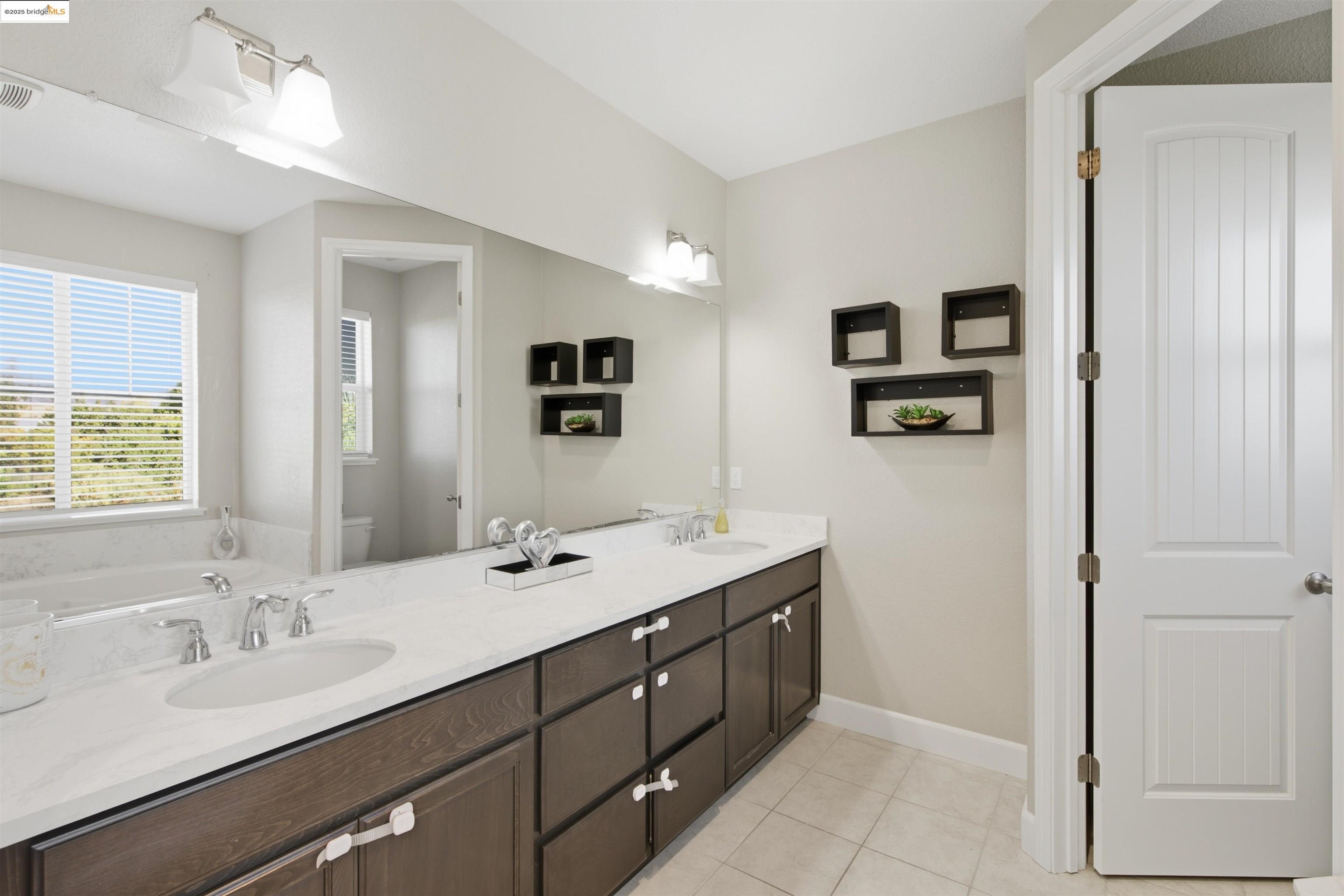 536 Aster Street Vacaville, CA 95688 - Photo 42 of 53 Bathroom with double vanity, light tile patterned flooring, and a garden tub