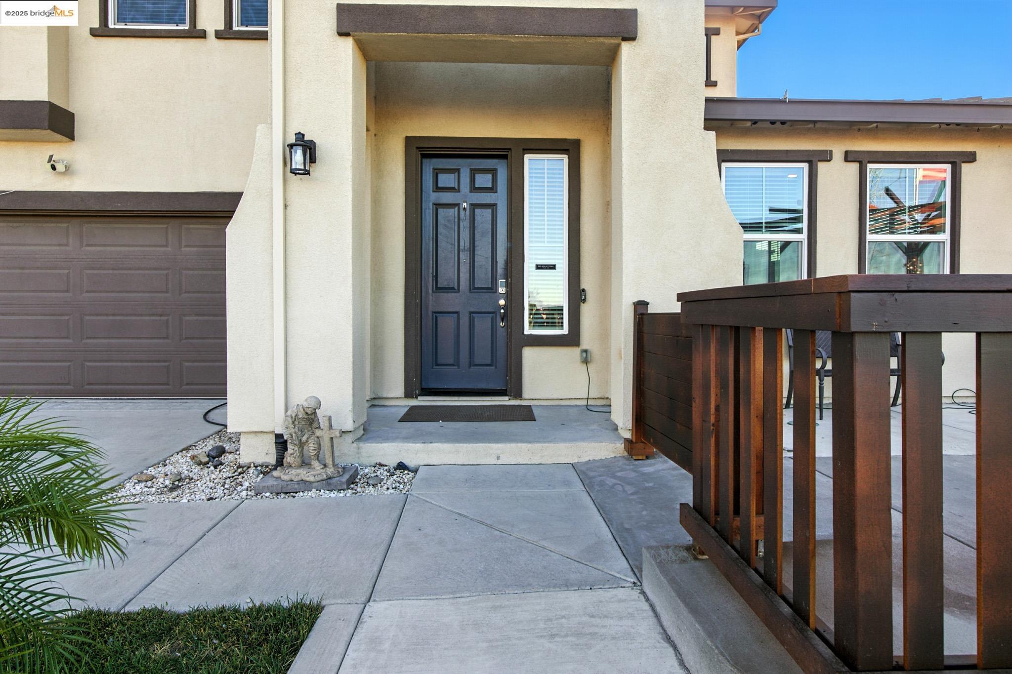 536 Aster Street Vacaville, CA 95688 - Photo 5 of 53 Doorway to property with stucco siding, driveway, and an attached garage