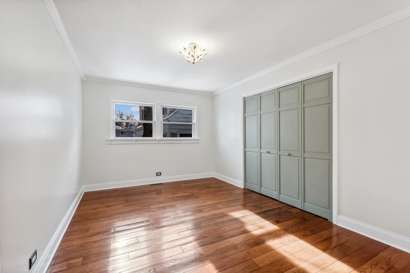 207 North Happ Road Northfield, IL 60093 - Photo 13 of 28 a view of an empty room with wooden floor and a window