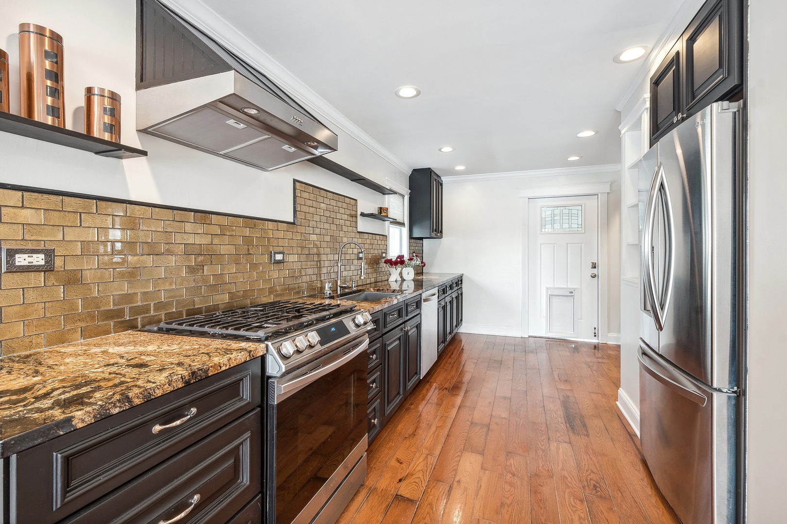 207 North Happ Road Northfield, IL 60093 - Photo 5 of 28 a kitchen with stainless steel appliances granite countertop a stove and a refrigerator