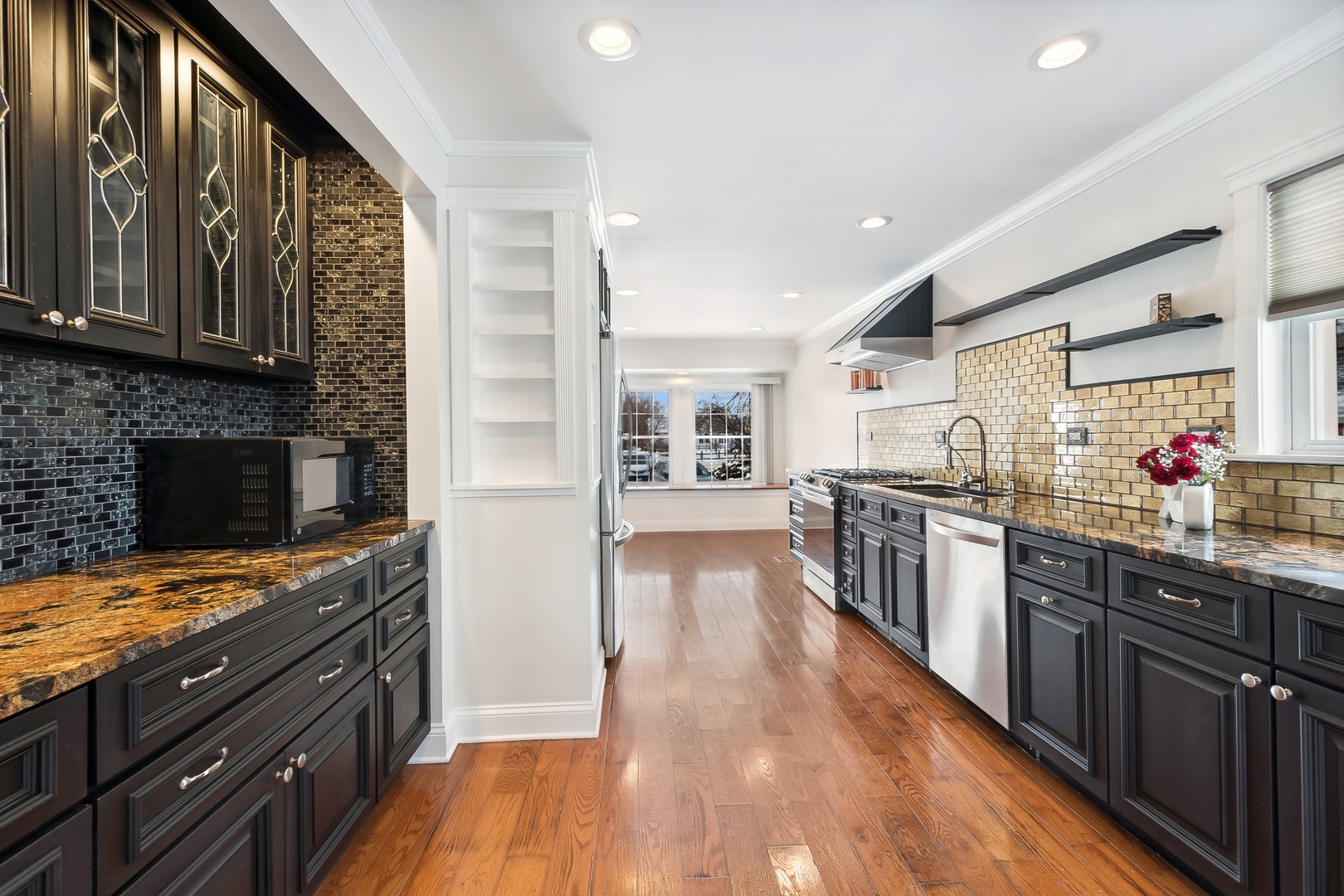 207 North Happ Road Northfield, IL 60093 - Photo 6 of 28 a kitchen with lots of counter top space and wooden floor