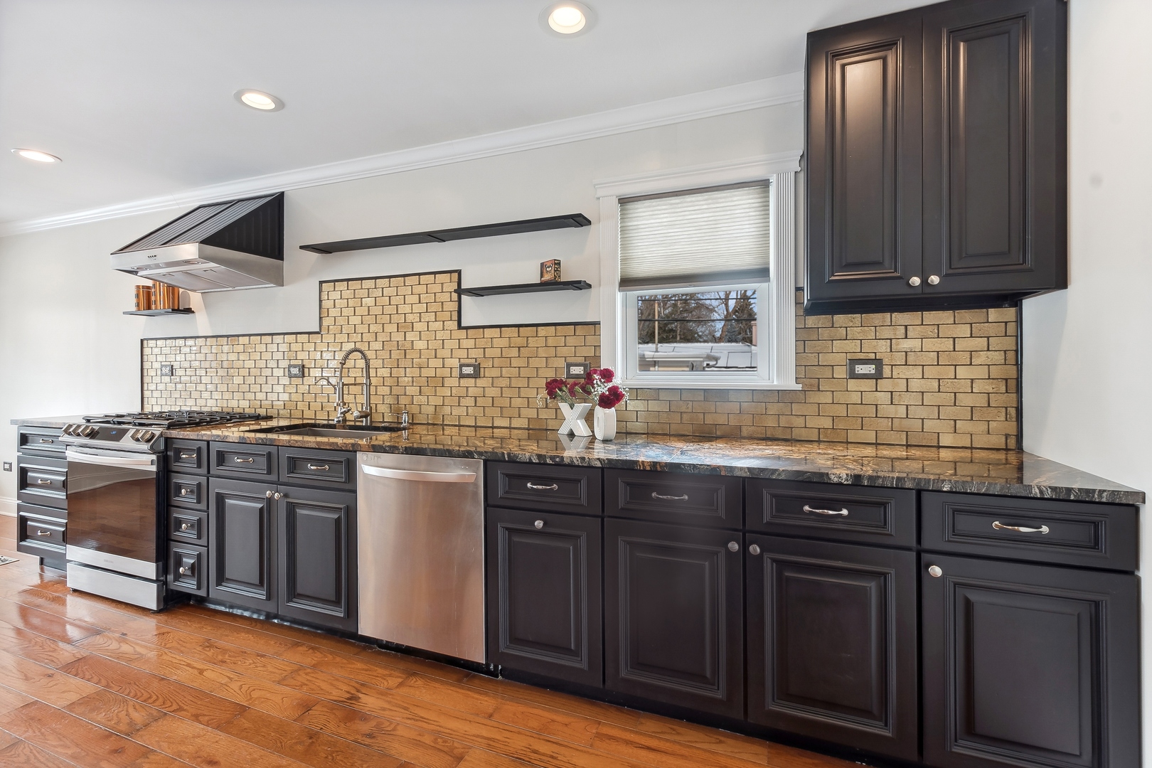 207 North Happ Road Northfield, IL 60093 - Photo 8 of 28 a kitchen with stainless steel appliances granite countertop wooden cabinets and sink
