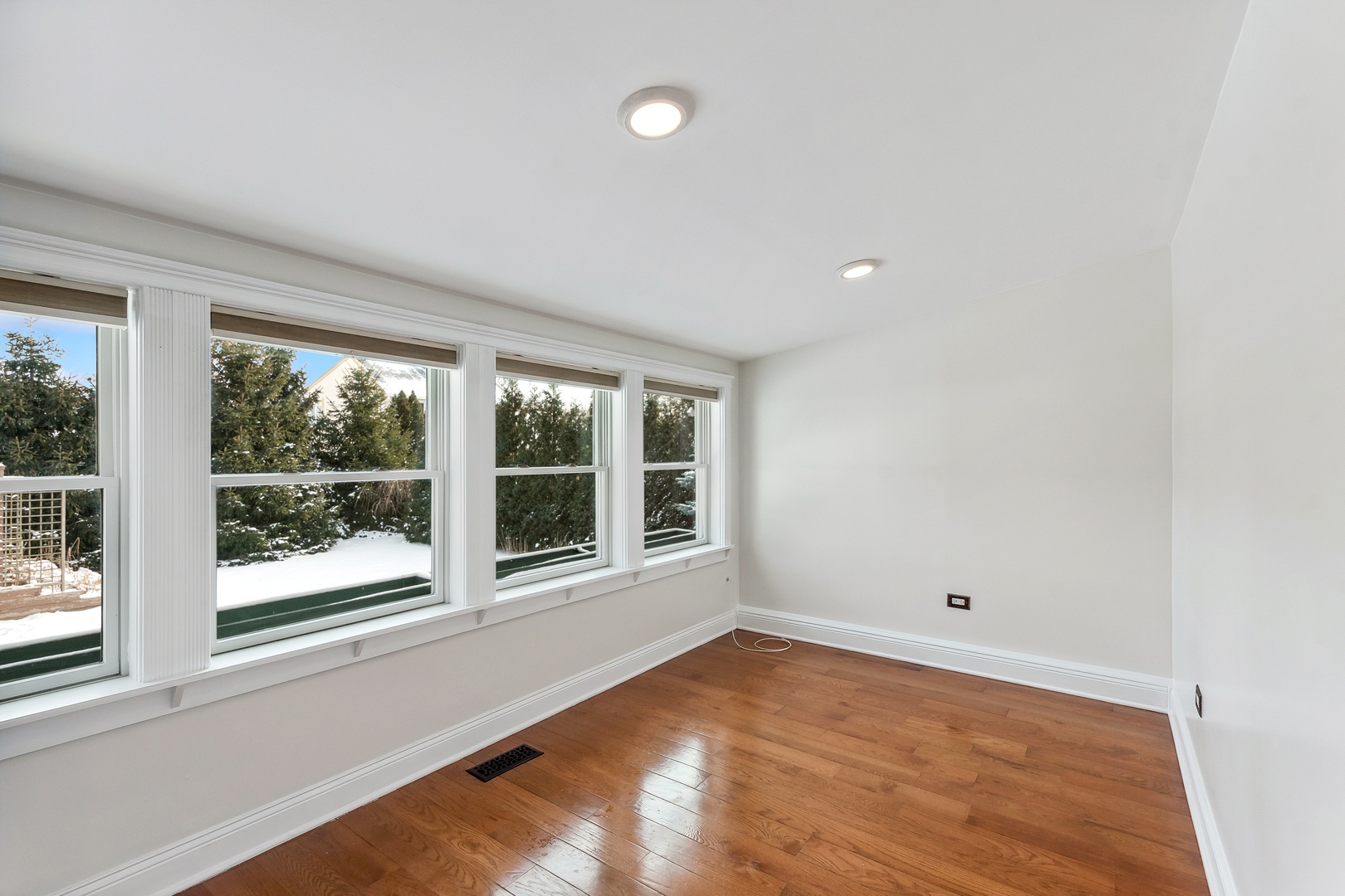 207 North Happ Road Northfield, IL 60093 - Photo 10 of 28 an empty room with wooden floor and windows