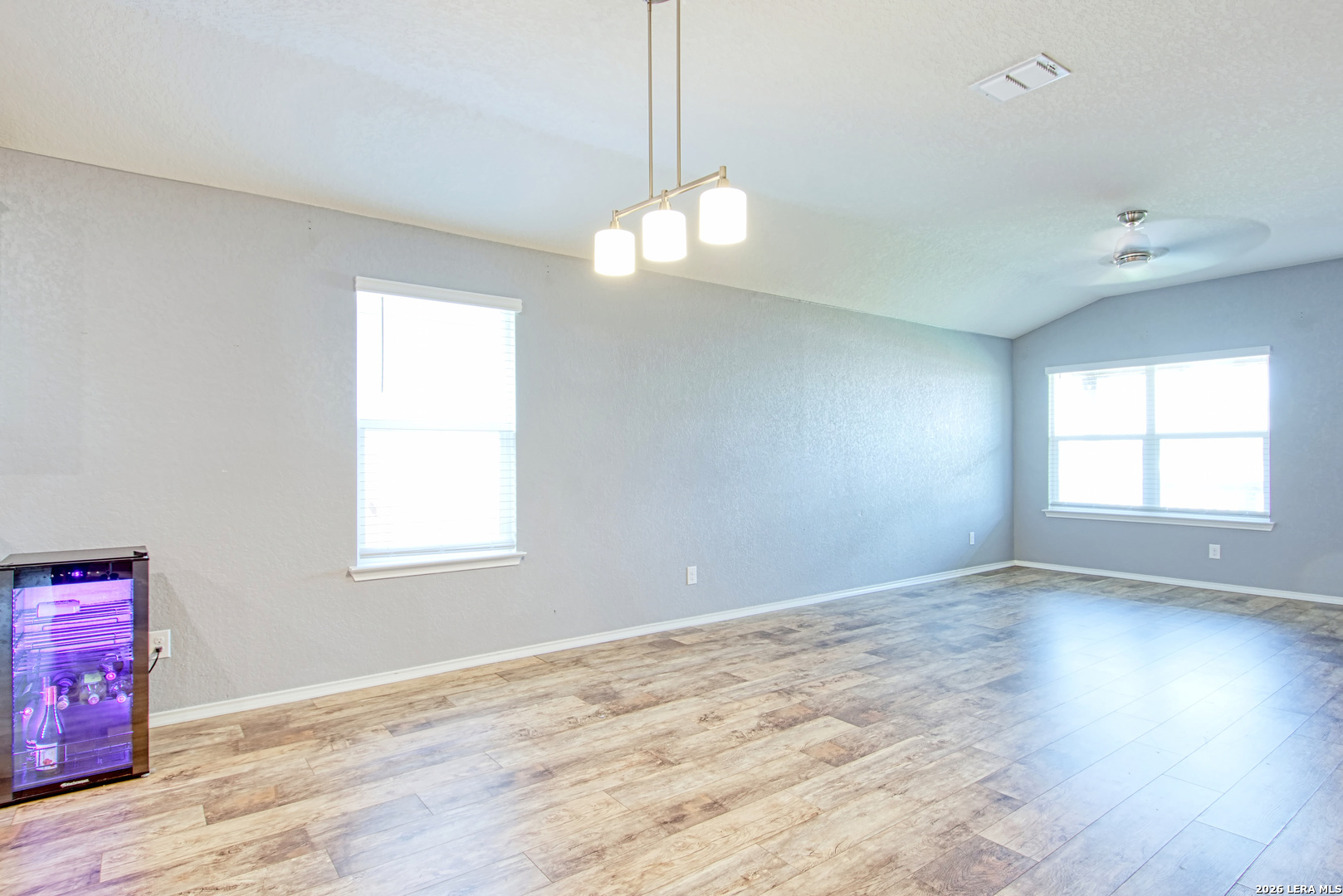 29516 Winter Copper Bulverde, TX 78163 - Photo 14 of 42 a view of an empty room with wooden floor and a window