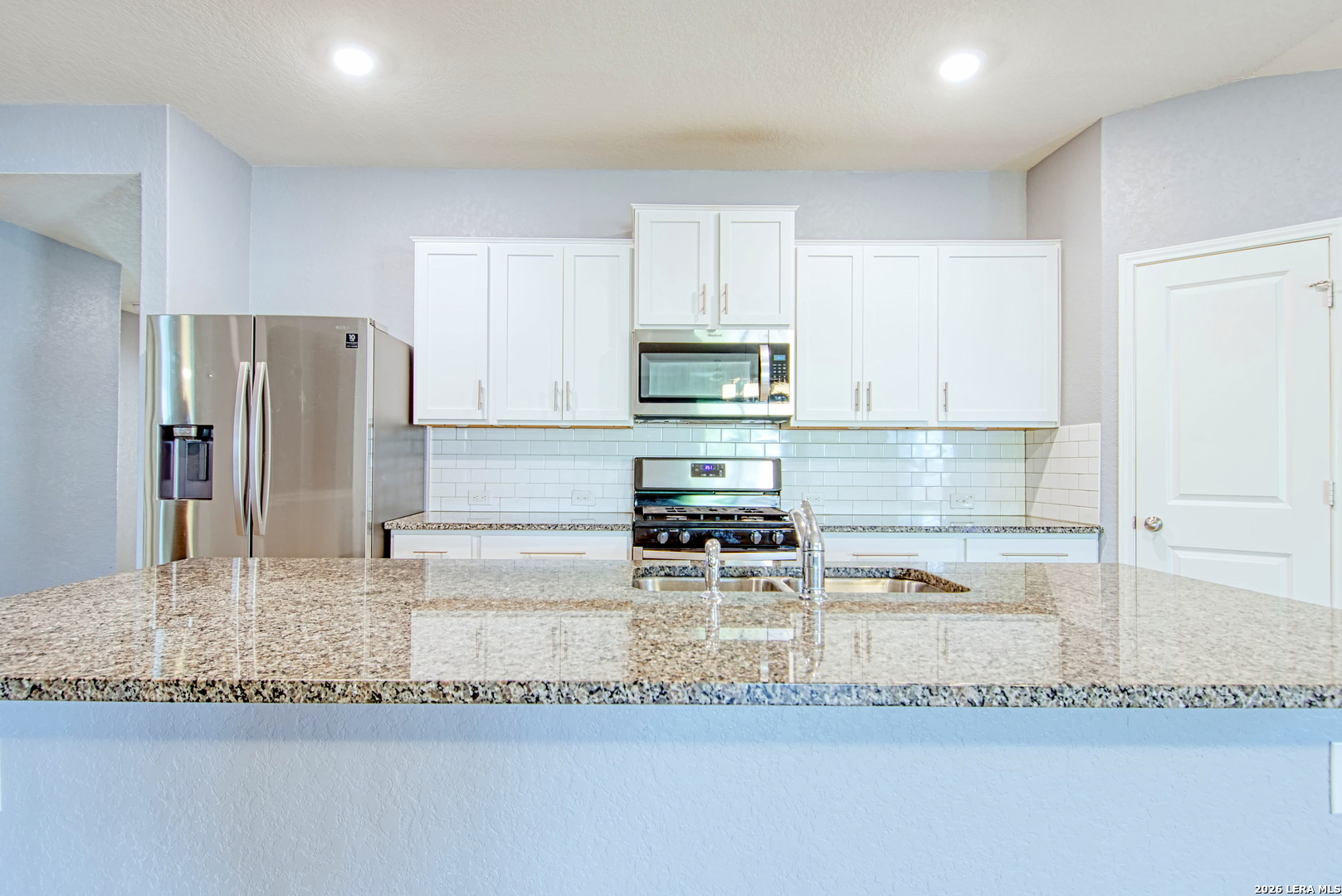 29516 Winter Copper Bulverde, TX 78163 - Photo 10 of 42 a kitchen with stainless steel appliances granite countertop a refrigerator a stove and a sink