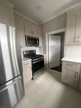 a kitchen with a refrigerator stove and sink
