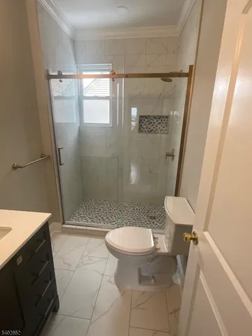 a bathroom with a sink a toilet and a shower