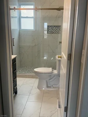 a bathroom with a toilet and a shower