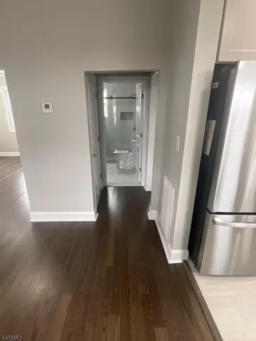 a view of a hallway with wooden floor