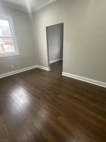 a view of walk in closet with wooden floor