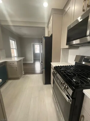 a kitchen with stainless steel appliances granite countertop a stove and a refrigerator