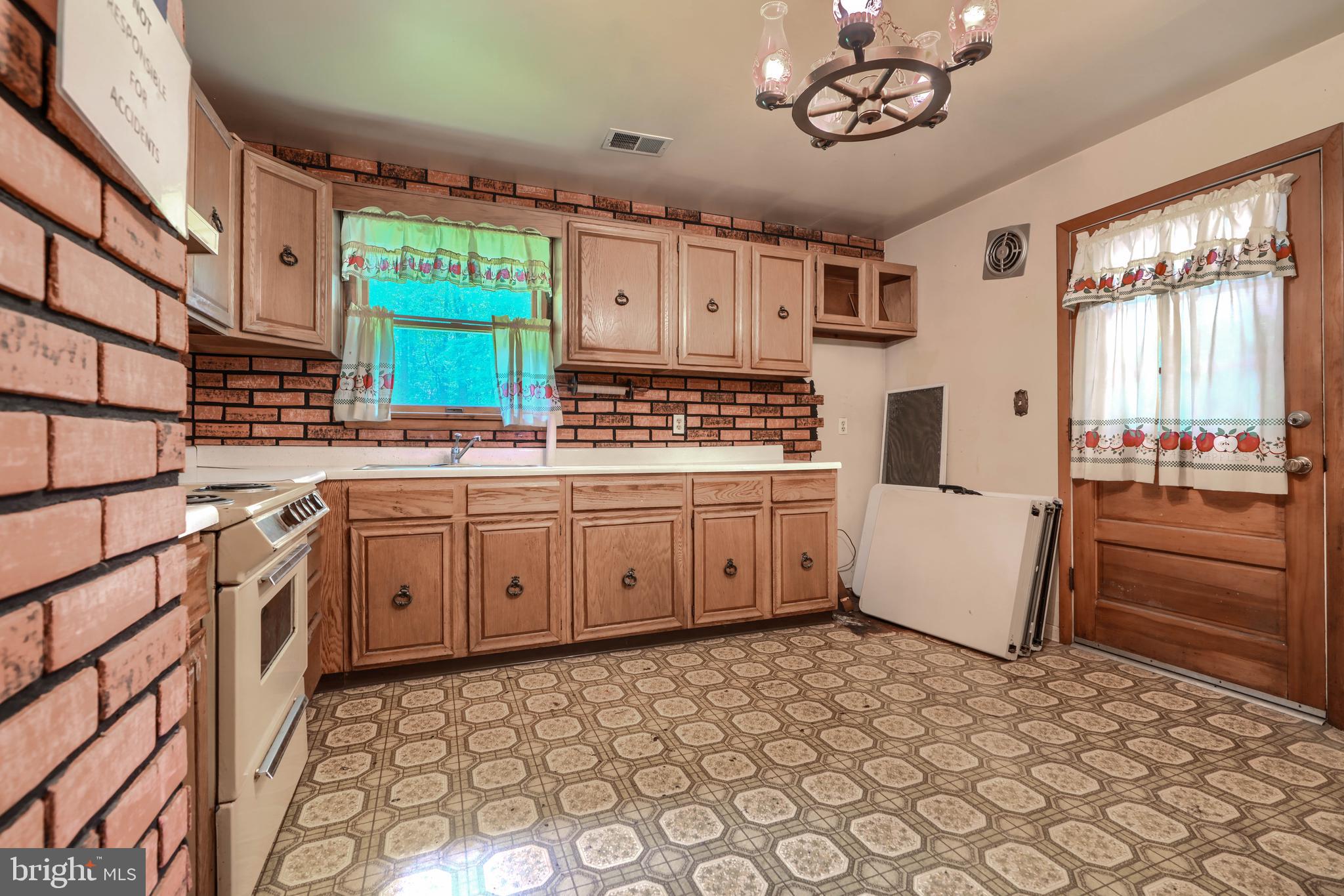 3743 Schroeder Avenue Perry Hall, MD 21128 - Photo 19 of 60 a kitchen with stainless steel appliances a stove a sink and a refrigerator