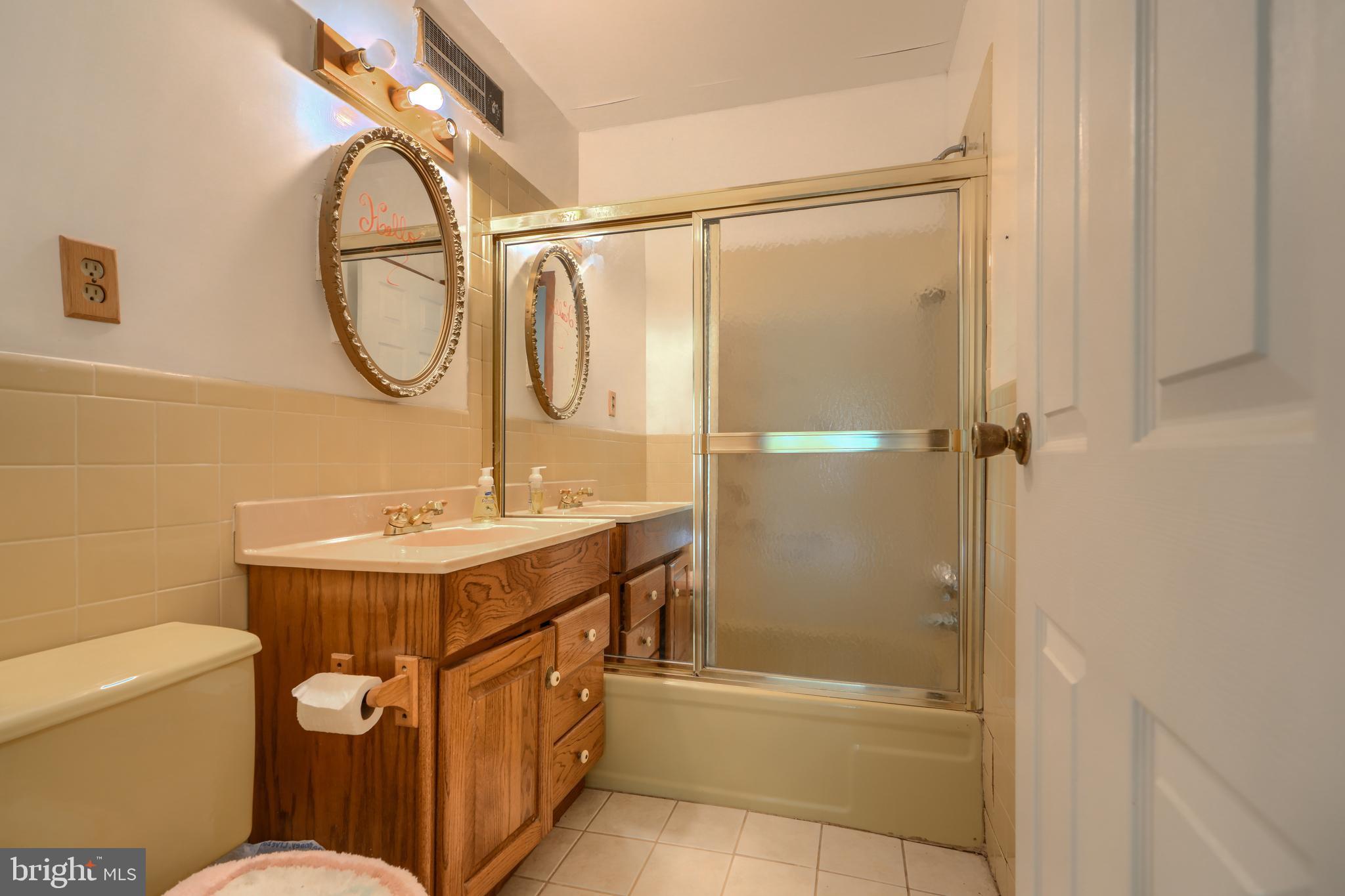 3743 Schroeder Avenue Perry Hall, MD 21128 - Photo 34 of 60 a bathroom with a sink a vanity mirror and toilet