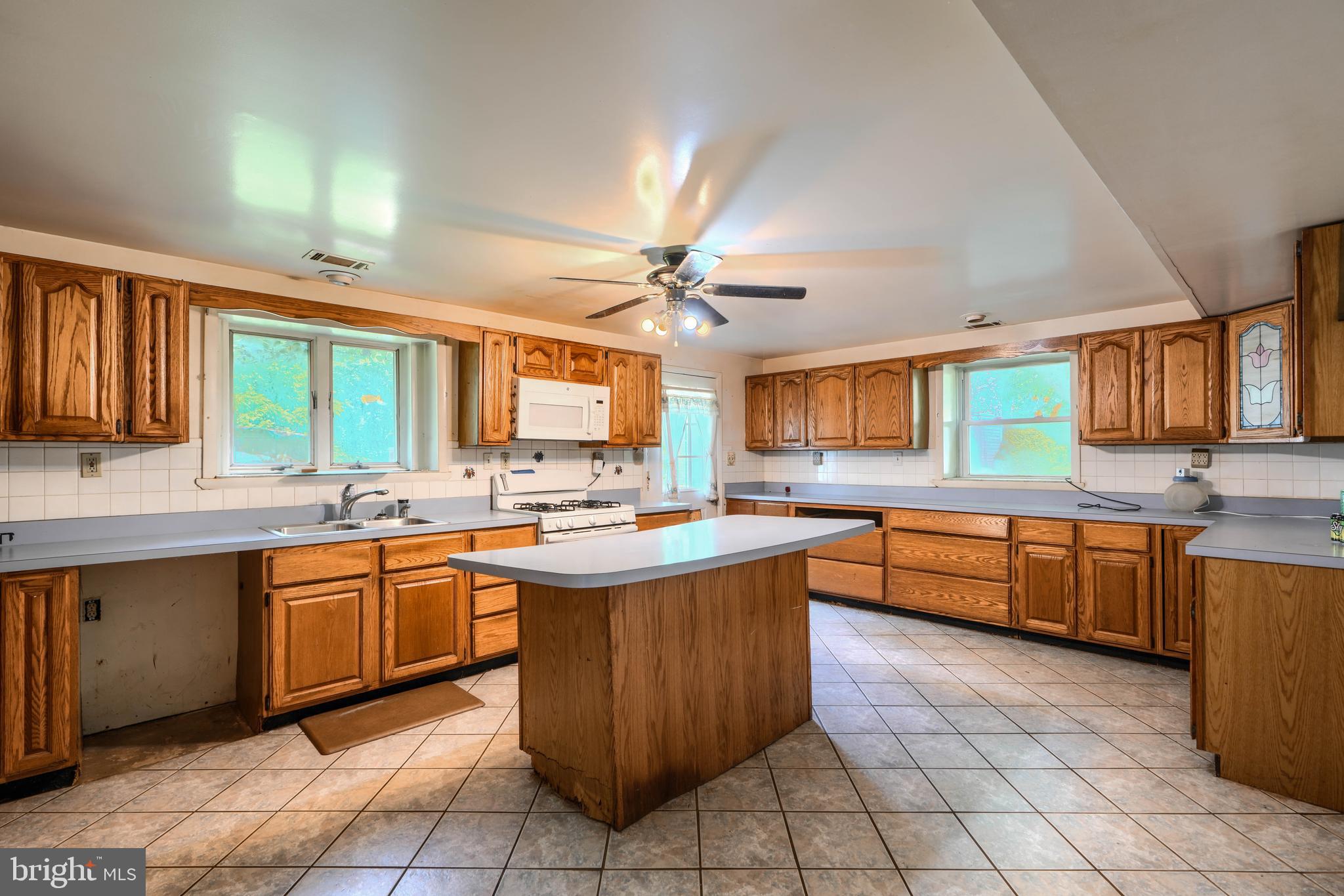 3743 Schroeder Avenue Perry Hall, MD 21128 - Photo 39 of 60 a kitchen with stainless steel appliances granite countertop sink stove top oven and cabinets