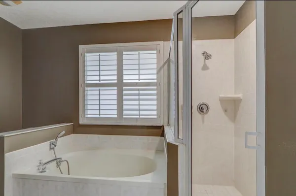 a white bath tub sitting next to a window