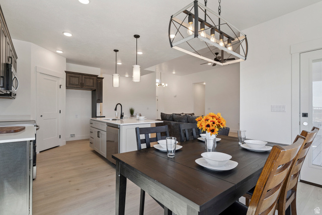 5777 West 4100 South Hooper, UT 84315 - Photo 7 of 41 Dining room featuring light wood-style floors and hanging lights