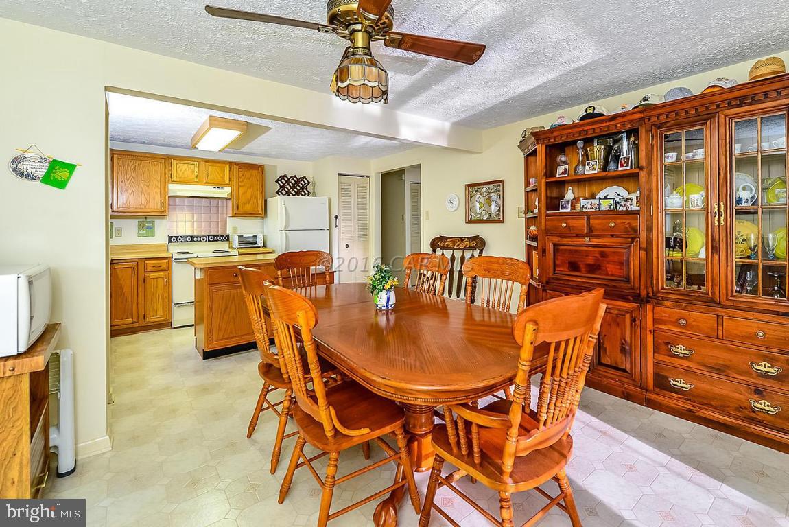 36 Watertown Road Ocean Pines, MD 21811 - Photo 14 of 51 a dining room with stainless steel appliances granite countertop a dining table and chairs with the wooden floor