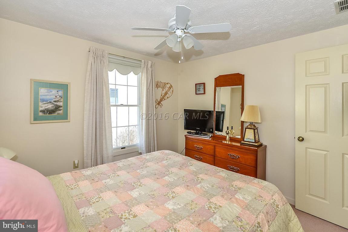 36 Watertown Road Ocean Pines, MD 21811 - Photo 22 of 51 a bedroom with a large bed and a flat tv screen on dresser