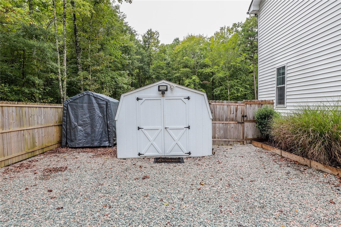 1113 Bradbury Road Moseley, VA 23120 - Photo 32 of 43 a view of backyard with small cabin and wooden fence