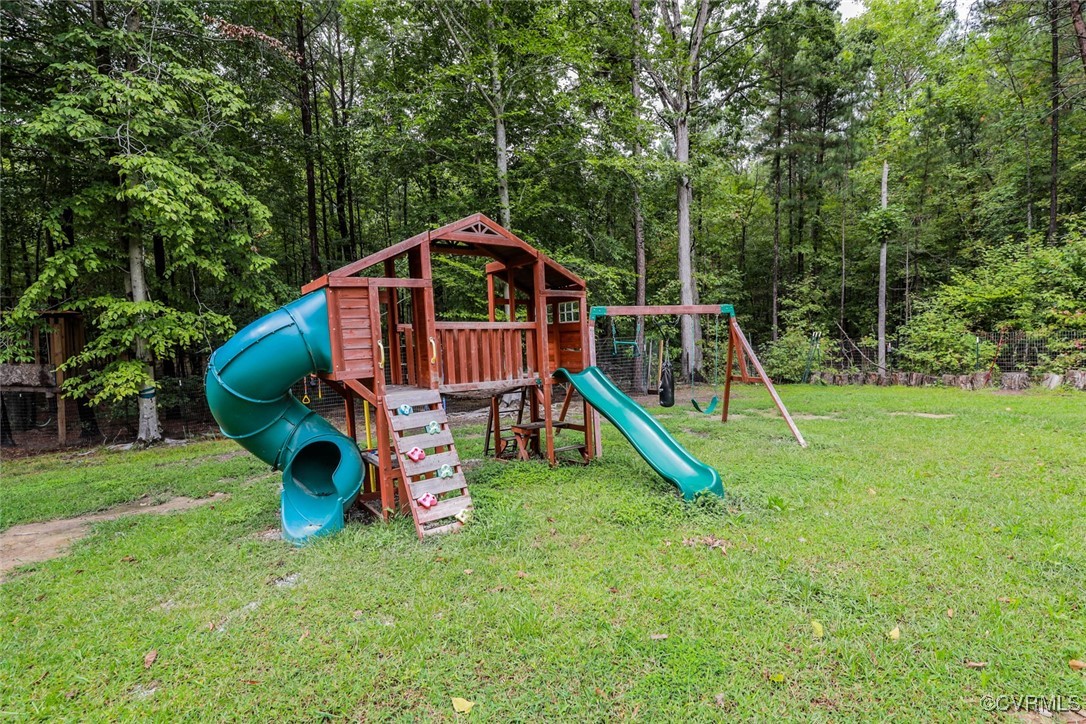 1113 Bradbury Road Moseley, VA 23120 - Photo 35 of 43 a view of a house with a slide and a child park