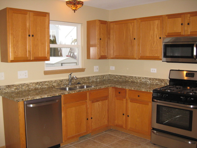 135 Treehouse Road Matteson, IL 60443 - Photo 3 of 21 a kitchen with granite countertop stainless steel appliances a stove a sink and a microwave