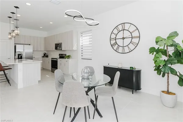 a living room with furniture a chandelier a mirror and a window