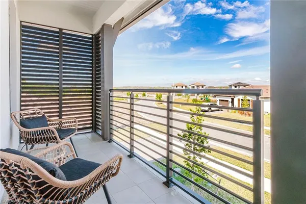 a view of a balcony with chairs