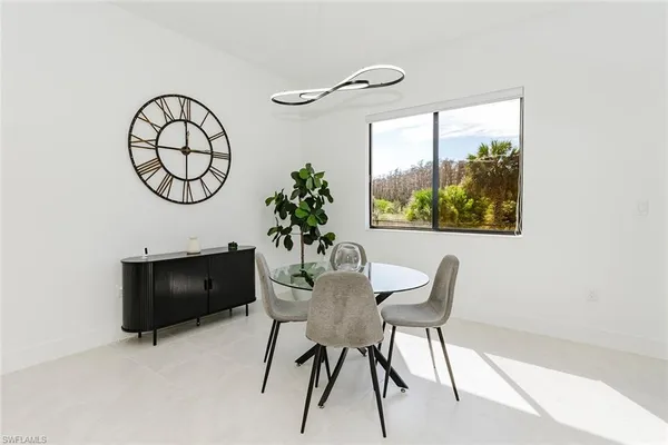 a view of a dining room with furniture and a potted plant