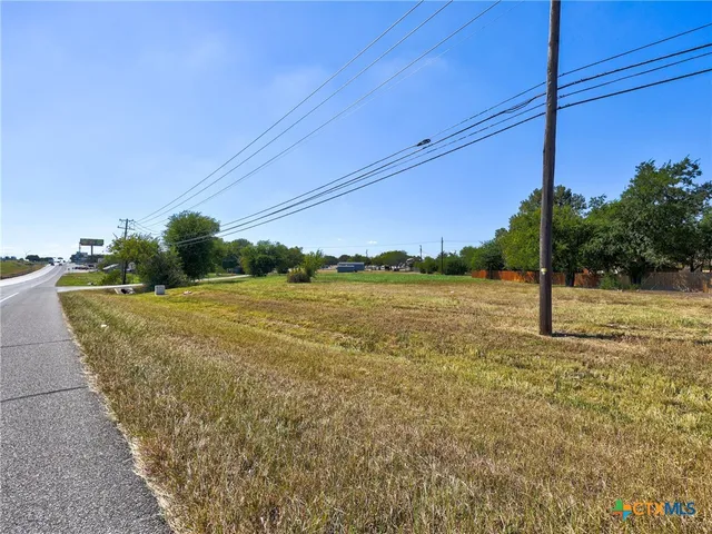 a view of a field with an ocean view