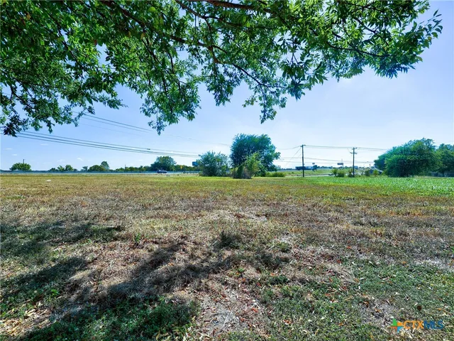 a view of a field with an trees